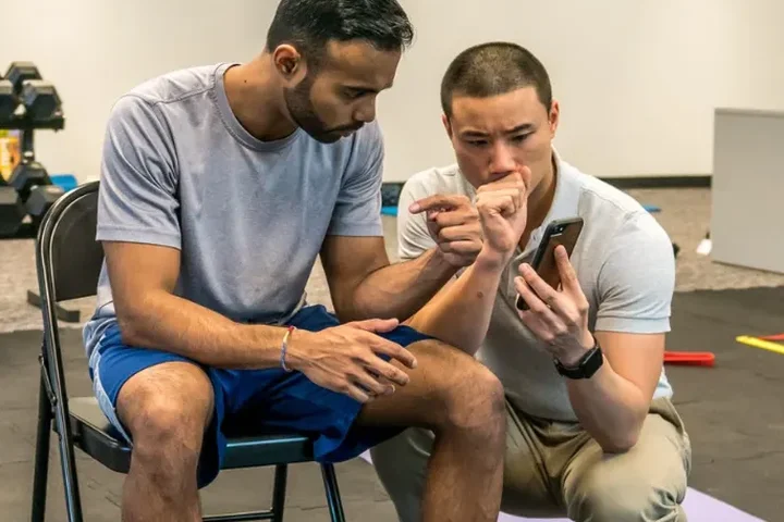 One-on-one movement assessment during a treatment session at Next Level PT