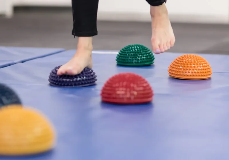 Physical therapist guiding a patient through balance and gait training